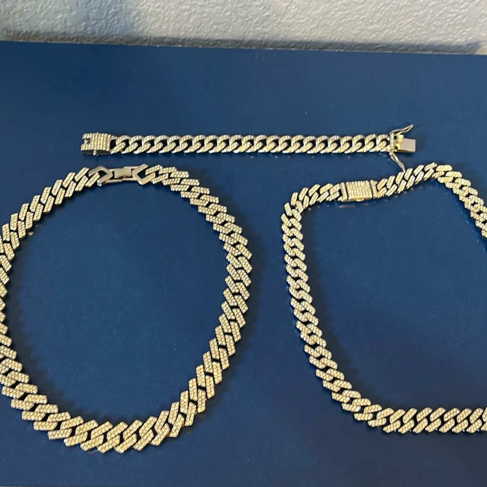 2 stainless steel Cuban link chains. 1 stainless steel bracelet